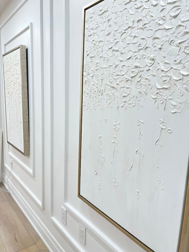 Luxury textured white wall art with floral details, framed in gold, inside Lash Layer & Brow Boutique in Pickering, Ontario.